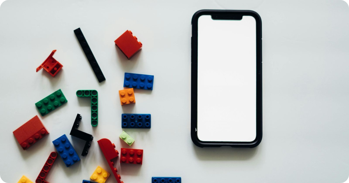 Lego building blocks and smartphone with white screen